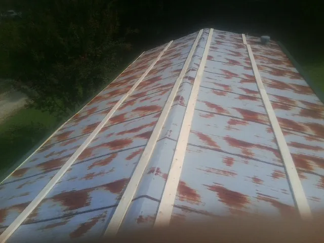 Rusted metal roof panels with new wood purlins before replacement — Storm Damage Roof Repair in Wacissa by Roofing Brothers